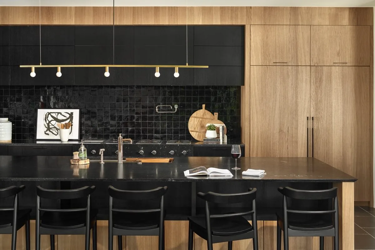 Remodeled kitchen with black tile and wood cabinetry