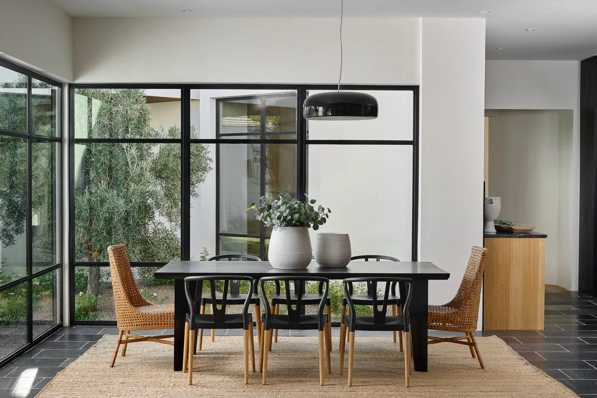 Dining space with steel-framed glass walls